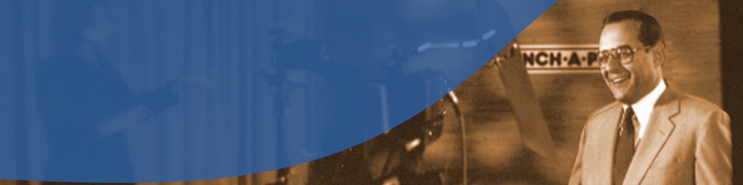 Vintage sepia toned photo of smiling man in suit, historical company image