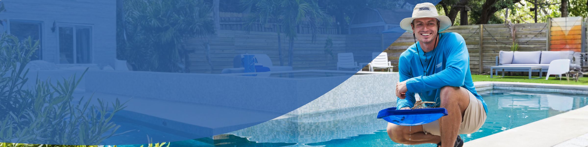 Pool technician kneeling beside residential swimming pool holding skimmer net